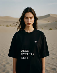 Person wearing a black t-shirt with 'ZERO EXCUSES LEFT' text in a desert setting